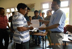 First Applicant of NRC Updation, Sonitpur distict, Shri Khogeswar Mudoi receives his Acknowledgment Receipt from Shri Jadav Saikia, ADC & Nodal officer, NRC, Sonitpur.